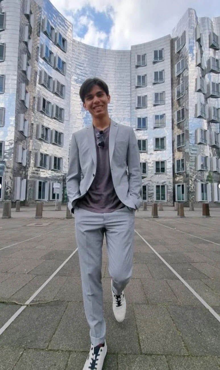 Portrait de Yannic Ulrich, fondateur de Proto Design, devant les bâtiments en acier du Medienhafen à Düsseldorf.